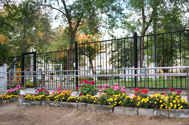 The entrance to the school grounds is decorated with flower beds
